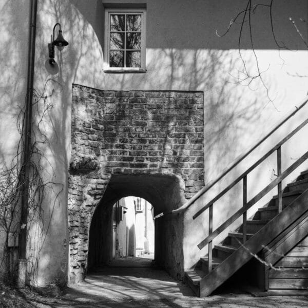 An aged brick building with an exterior stairway