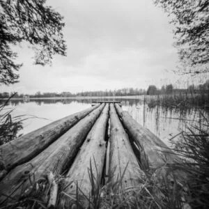 A monochrome image of a wooden dock, showcasing its rustic charm and simplicity