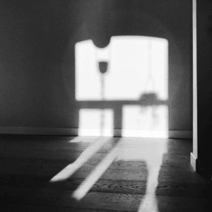 Black and white photograph of window shadow on the wall