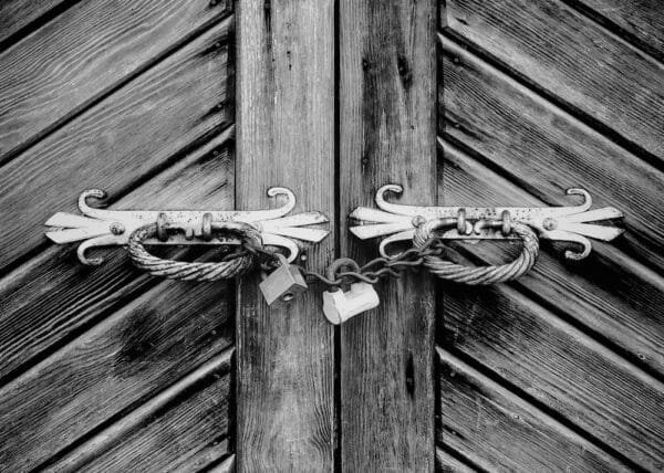 Two padlocks hanging on the door